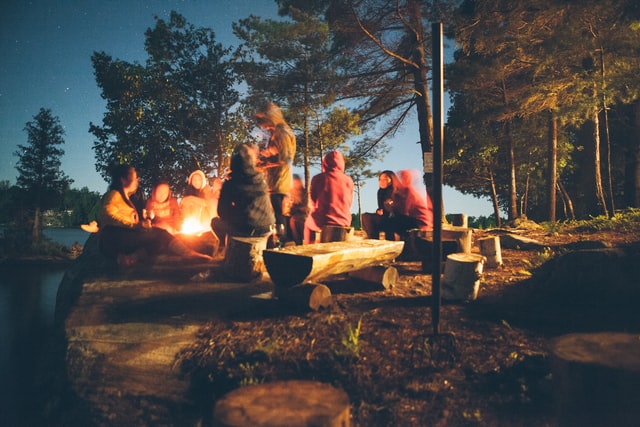 Sharing stories with the people you love around a campfire while camping at a national park