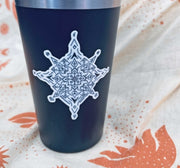 Wild Routed Glow in the Dark Compass Sticker in daylight on hydro flask cup